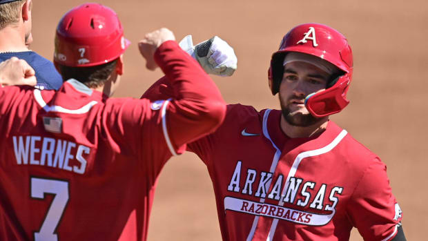 Razorbacks' John Bolton celebrates with Bobby Wernes after reaching first base against Auburn on Saturday.